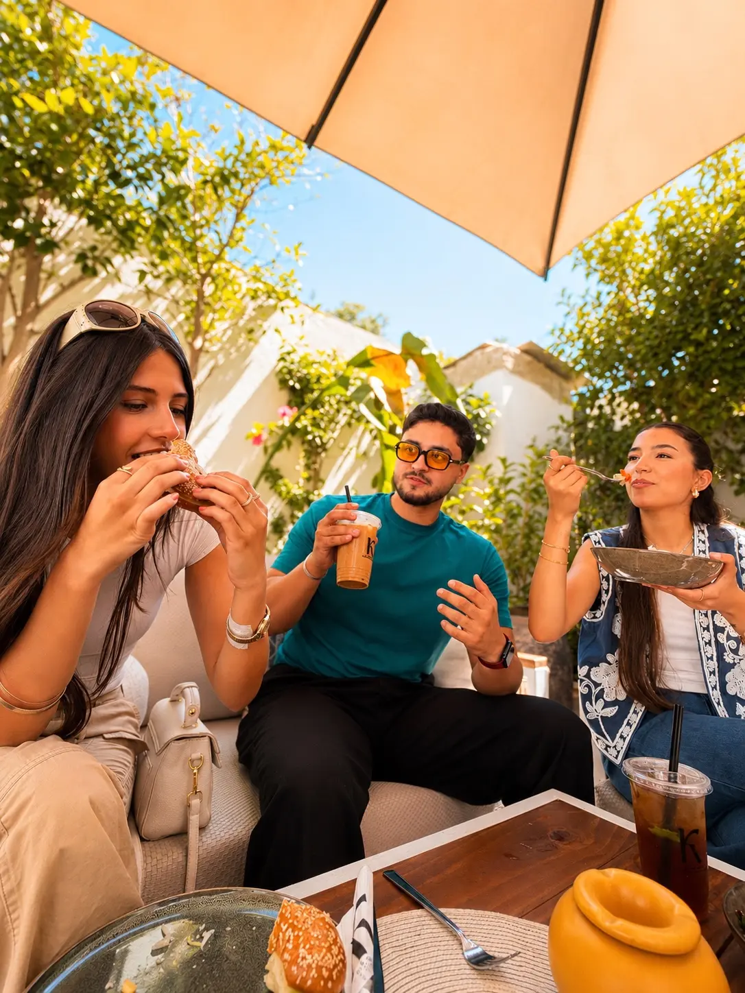 Friends enjoying food and drinks at K Coffee