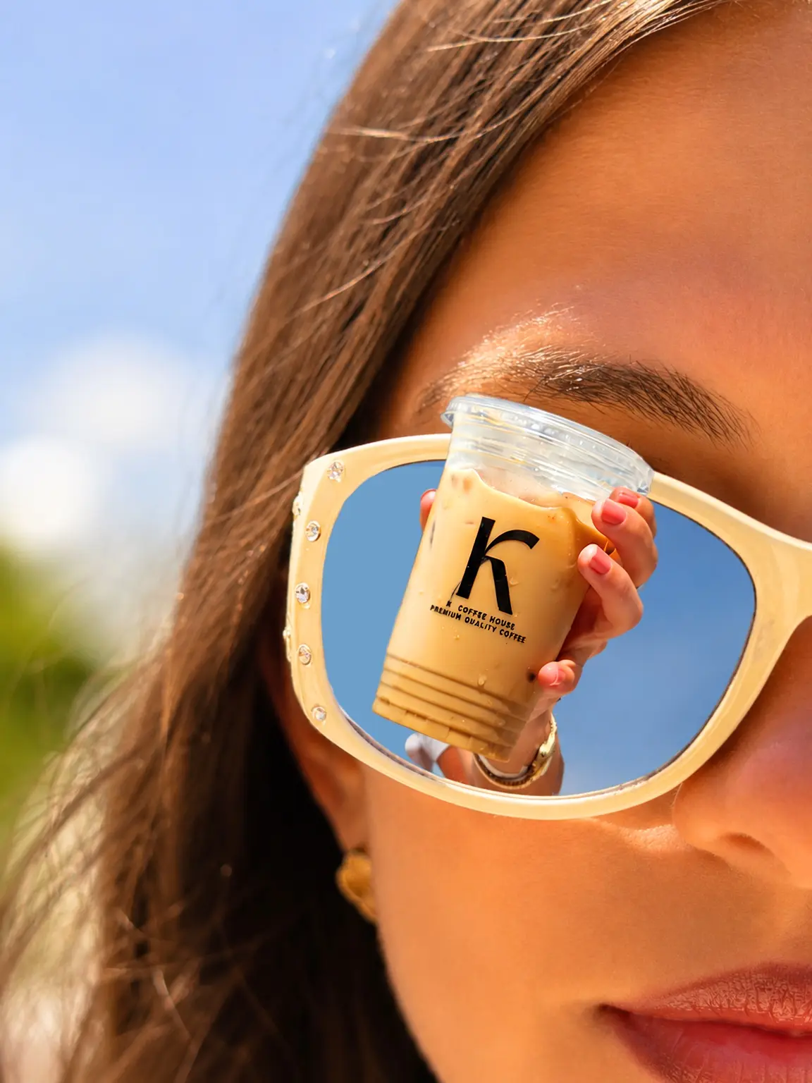 K Coffee iced drink reflected in sunglasses
